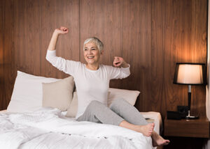 Woman stretching in her bed