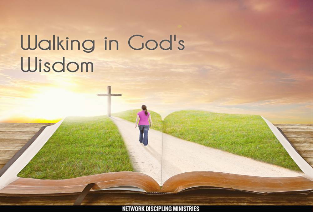 A woman walks along a road on a book towards the cross.